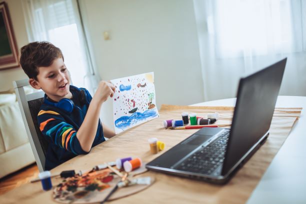 Happy young boy doing crafts with person online. Sometimes expressing what is going on verbally is hard for kids. With therapy for children, this is made easier. Our play therapists can help your children feel heard. Begin online play therapy in Florida today!