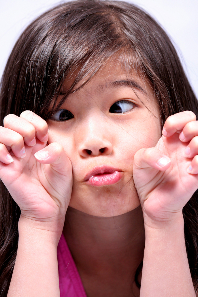 Young Asian girl making a silly face. If you're struggling to connect with your child, consider therapy for children with true you always. You can begin to connect and even heal your inner child. Begin Start your childs recovery in online play therapy in florida today!