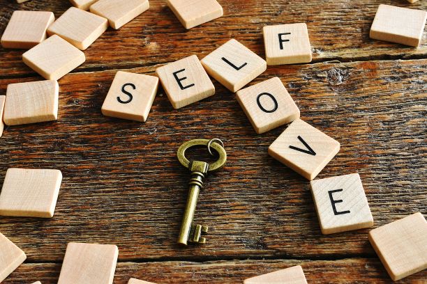 Self love scrabble tiles near a key. You deserve to love yourself fully. Learn how self-love coaching in Texas and self-love coaching in Florida can support your journey. If you’re interested in online coaching. Call us now and begin working with alexis.