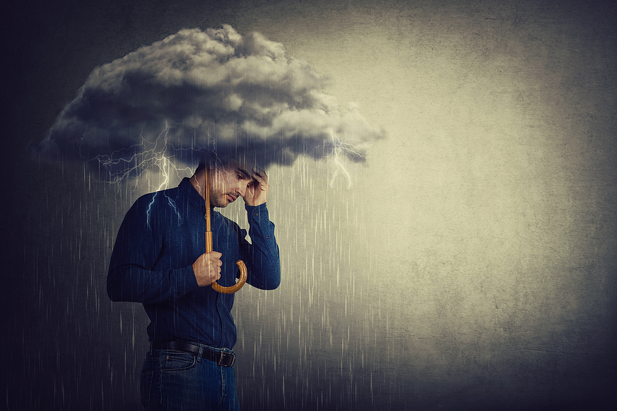 Man standing under umbrella upset with storm overhead. Complex trauma can add up and cause us to become stuck. However, you can move forward with a trauma therapist. Begin PTSD treatment and trauma therapy in Florida for help.