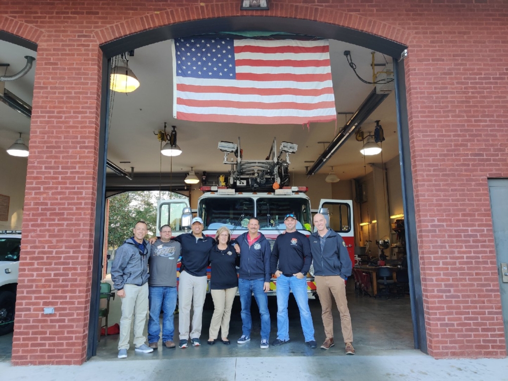Group of first responders in front of fire station and american flag. No matter what brings your to therapy for first responders in Brevard County, FL or statewide, we are here to help. We have many therapist specializing in first responders. Call now to get support in online therapy in Florida.
