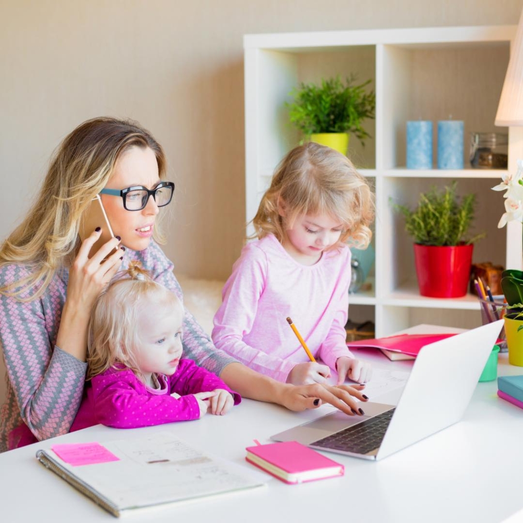 Mom on computer on phone with two daughters around desk. You're busy and that is normal. Get support from an online life coach who can help you balance mom life and work. Begin online coaching in Texas, Florida, nationwide, or internationally today!