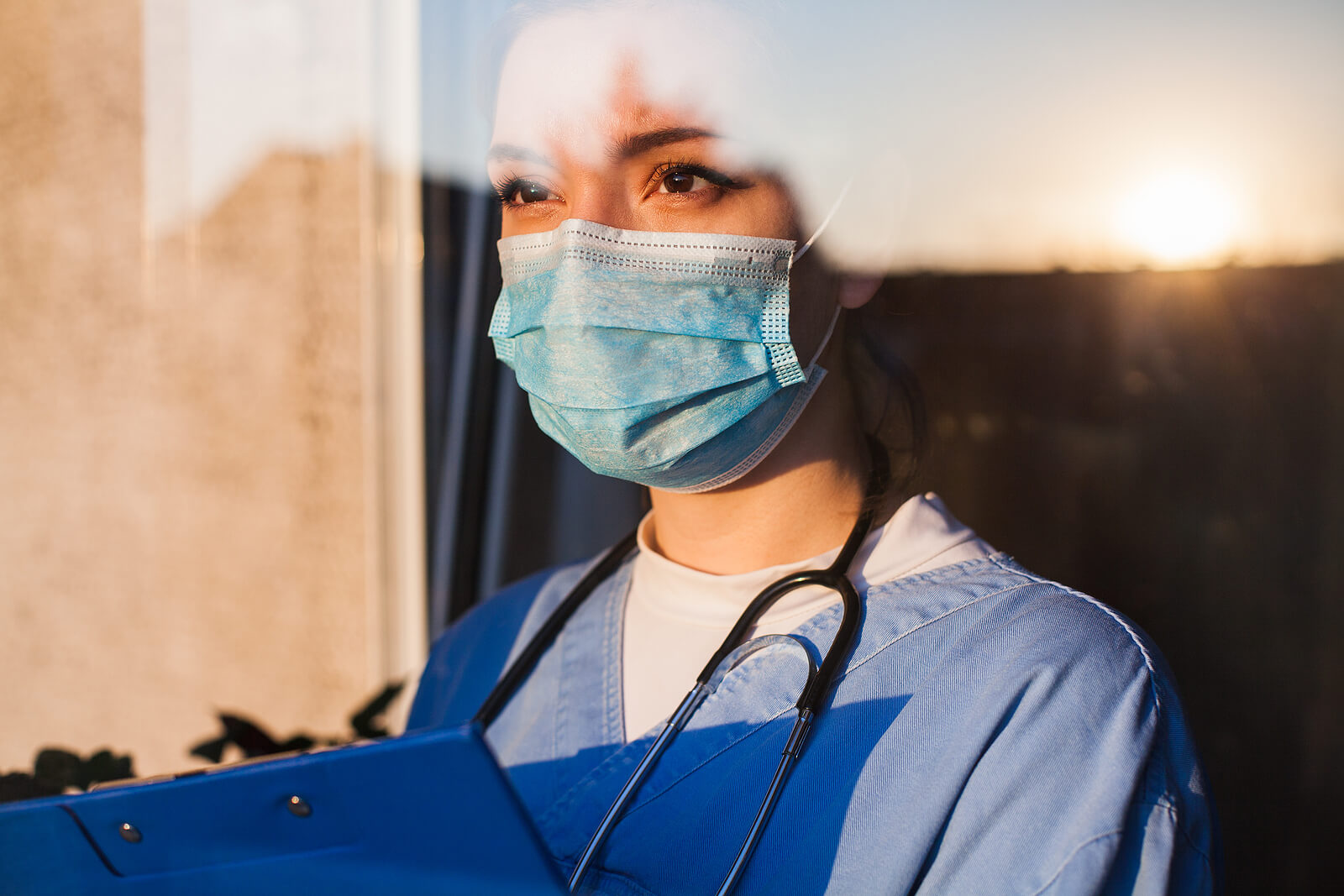 Nurse in blue scrubs and mask looking out window. We know that being in a high tension field takes a toll on you at times. Get help with therapy for first responders in Brevard County, FL today!. You will work with therapists specializing in therapy for first responders.