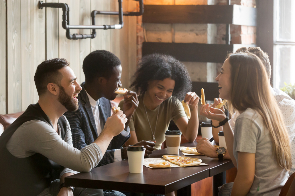 Happy friends and family eating and drinking coffee together. When you’re able to find freedom with your family with eating disorder treatment. Call now and begin eating disorder support in brevard county, FL for families.