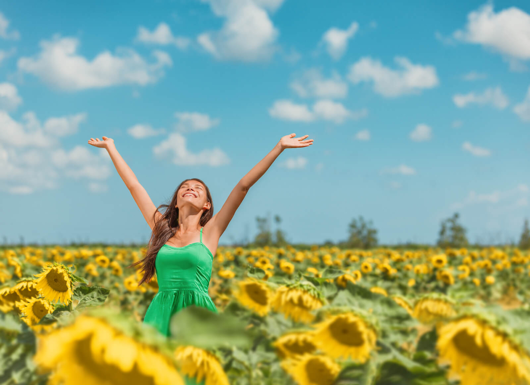 Woman in sunflower field with arms stretched out. Curious about coaching for women? You have come to the right online life coaches. Schedule a consult and see if online life coaching in Texas, Florida, or nationwide may help!