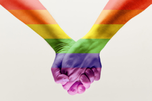 Individuals with pride colors holding hands. We all deserve love, and we are here to provide LGBTQIA counseling in Brevard County, FL  for couples. Call now and see how LGBTQ affirming therapy may provide the structure you need to address your relationships. 