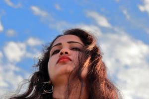 Woman looking out to clouds in blue sky. EMDR therapy in Florida can help you work through depression, trauma, PTSD, and anxiety. Talked with a skilled online therapist in Florida and see how we can support you!