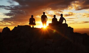 Teens standing on mountains at sunset. Online therapy for teens in florida can help your teen feel more in control. We have PTSD treatment and trauma therapy, anxiety treatment, depression therapy, and more. Call now!