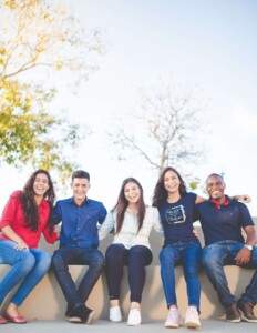 Group of young adults smiling. If you are struggling with stress, anxiety, and depression, our online therapists can help. Try therapy for young adults in Florida, anxiety treatment, or stress therapy today!