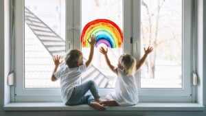 Children painting a rainbow on glass door. While we want to help our children thrive, we don't want to diminsh their identity. Learn some helpful ADHD parenting in Florida and get family therapy, individal therapy, or ADHD therapy for kids soon!