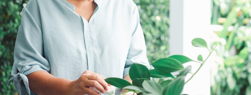 Woman tending to plants mindfully. Mindfulness for beginners in Florida is a great tool to manage stress, anxiety, and trauma. See how online therapy in florida can help you.