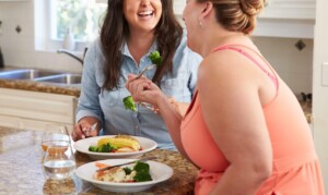 Woman mindfully eating and laughing. If you are curious about a mindfulness practice, our online therapist can help you understand mindfulness for beginners in Florida. Call now and talk with a skilled therapist or begin online therapy soon!
