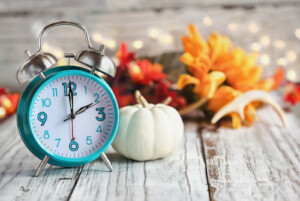 A clock rests on a table with fall and winter decor. Learn how about the support an online therapist in Brevard County, FL can offer this holiday season. Contact a marriage counselor in Brevard County, FL to learn more about the benefits of individual therapy in Brevard County, FL today. 