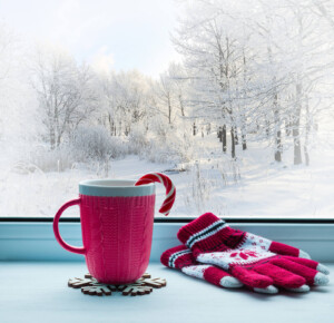 A cup with a candy cane rests on a windowsill next to a pair of mittens. An online therapist in Brevard County, FL can offer support with addressing holiday anxiety. Learn more about how a trauma therapist in Florida can offer support today. 