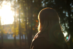 A close-up of a person standing in the light of the rising sun as they look off into the distance. An online therapist in Brevard County, FL can help cultivate gratitude through individual therapy in Brevard County, FL. Learn more about the support a family therapist in Brevard County, FL can offer. 