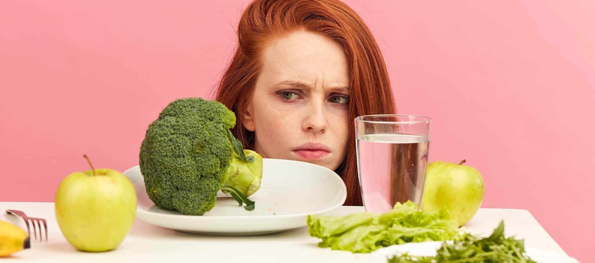 Woman peering suspicously at plate of broccoli. Dealing with an eating disorder sucks! Get help from a skilled eating disorder therapist who gets it. Begin eating disorder treatment in Florida today!