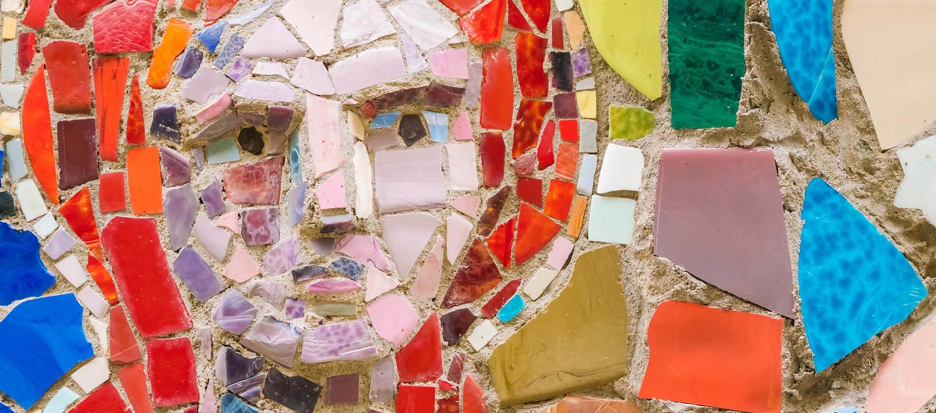 Sad face made from colorful broken pieces of pottery. If you're dealing with complex trauma or secondary trauma, then maybe you could benefit from working with a trauma therapist who specialized in PTSD treatment and trauma therapy plus complex trauma. Begin online therapy in Florida with us today!