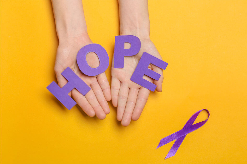 hands holding letters spelling the word HOPE