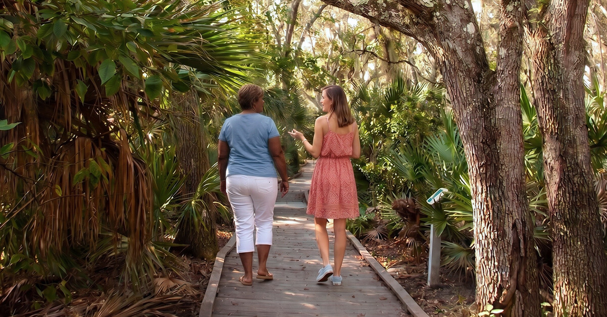 Therapist and client in a walk and talk session along the wooden boardwalk at Merritt Island National Wildlife Refuge