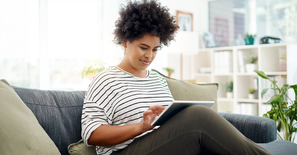 Person using a tablet at home while learning coping strategies for anxiety