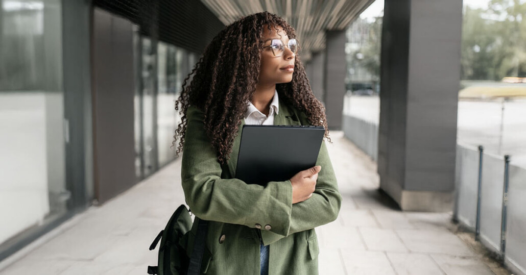 Person holding a tablet and folder appears to be considering seeking therapy for anxiety and stress